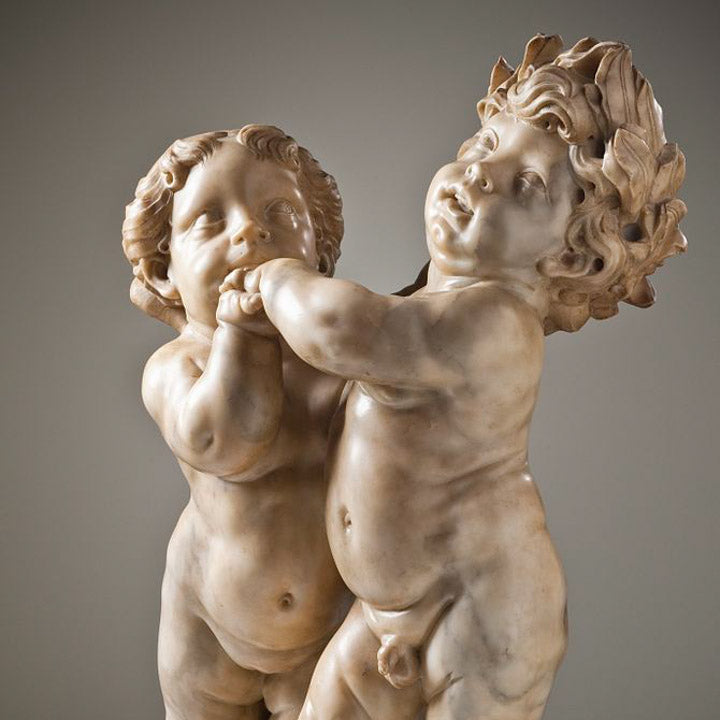 winged female genius crowning a putto with a laurel wreath