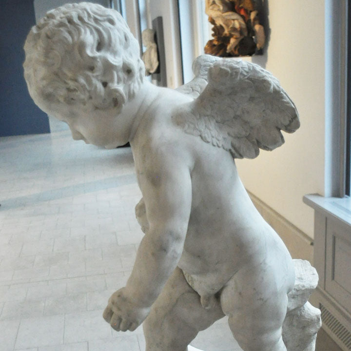 cupid carving a bow