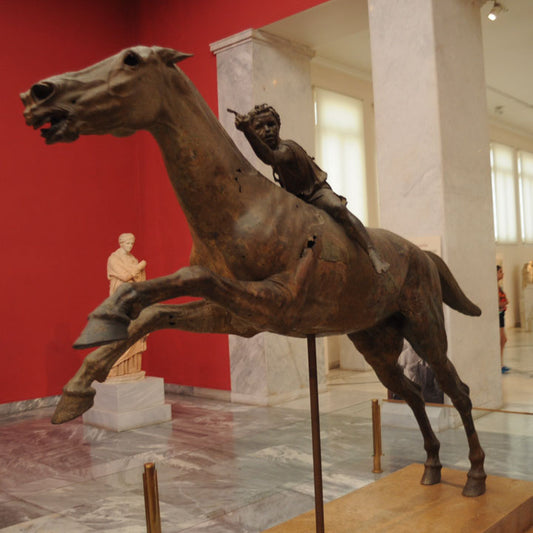 bronze statue of a horse and young jockey